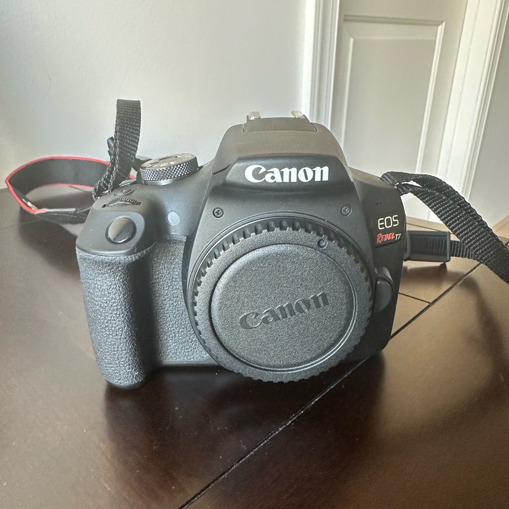 Canon EOS Rebel T7 DSLR camera (Black) with 18-55 mm lens and 75-300 mm lens.